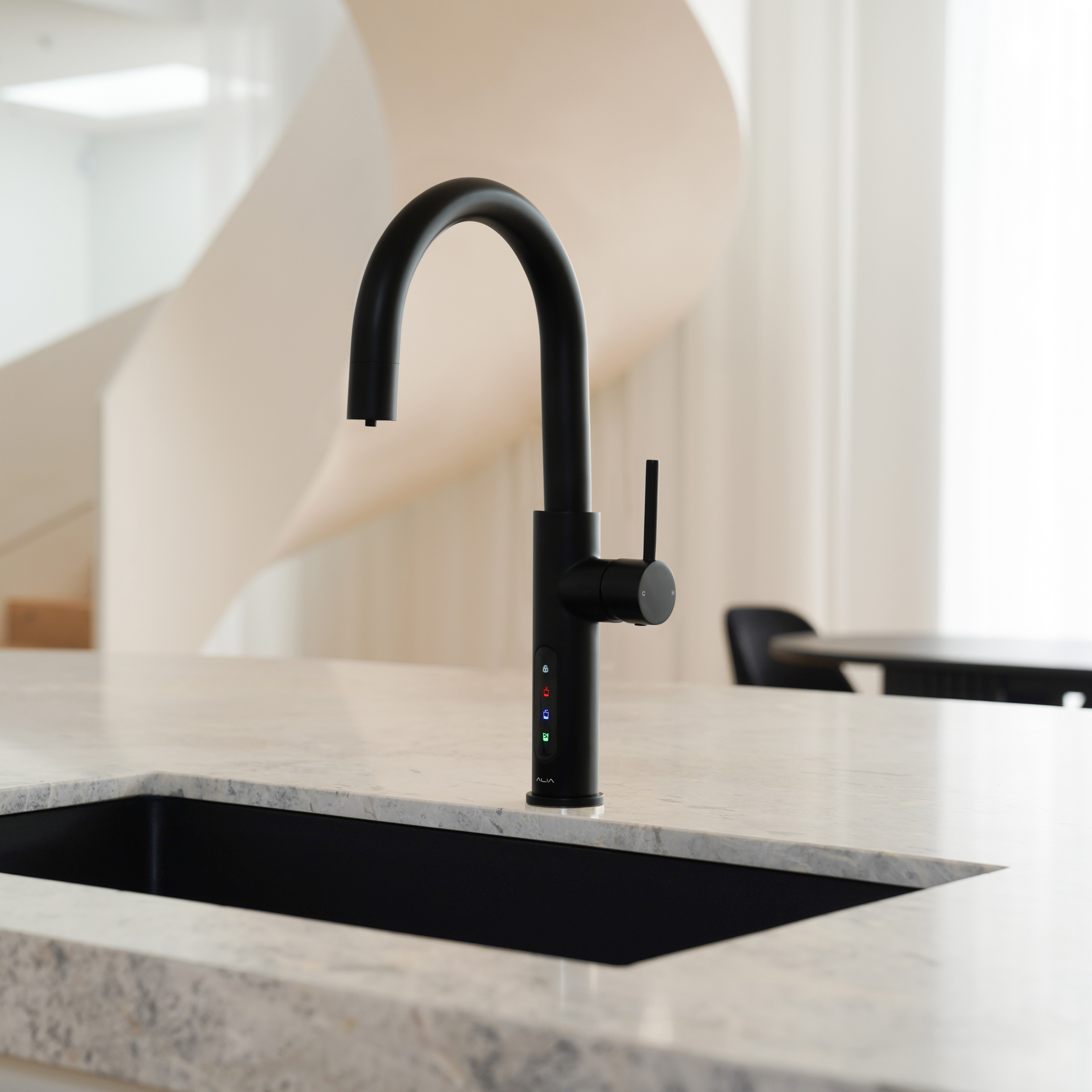 Alia X51 instant hot, cold, and sparkling filtered water tap in matte black accenting a luxury kitchen, highlighting its premium filtered water and bold contemporary design.